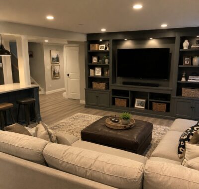 Finished basement entertainment area with built ins.